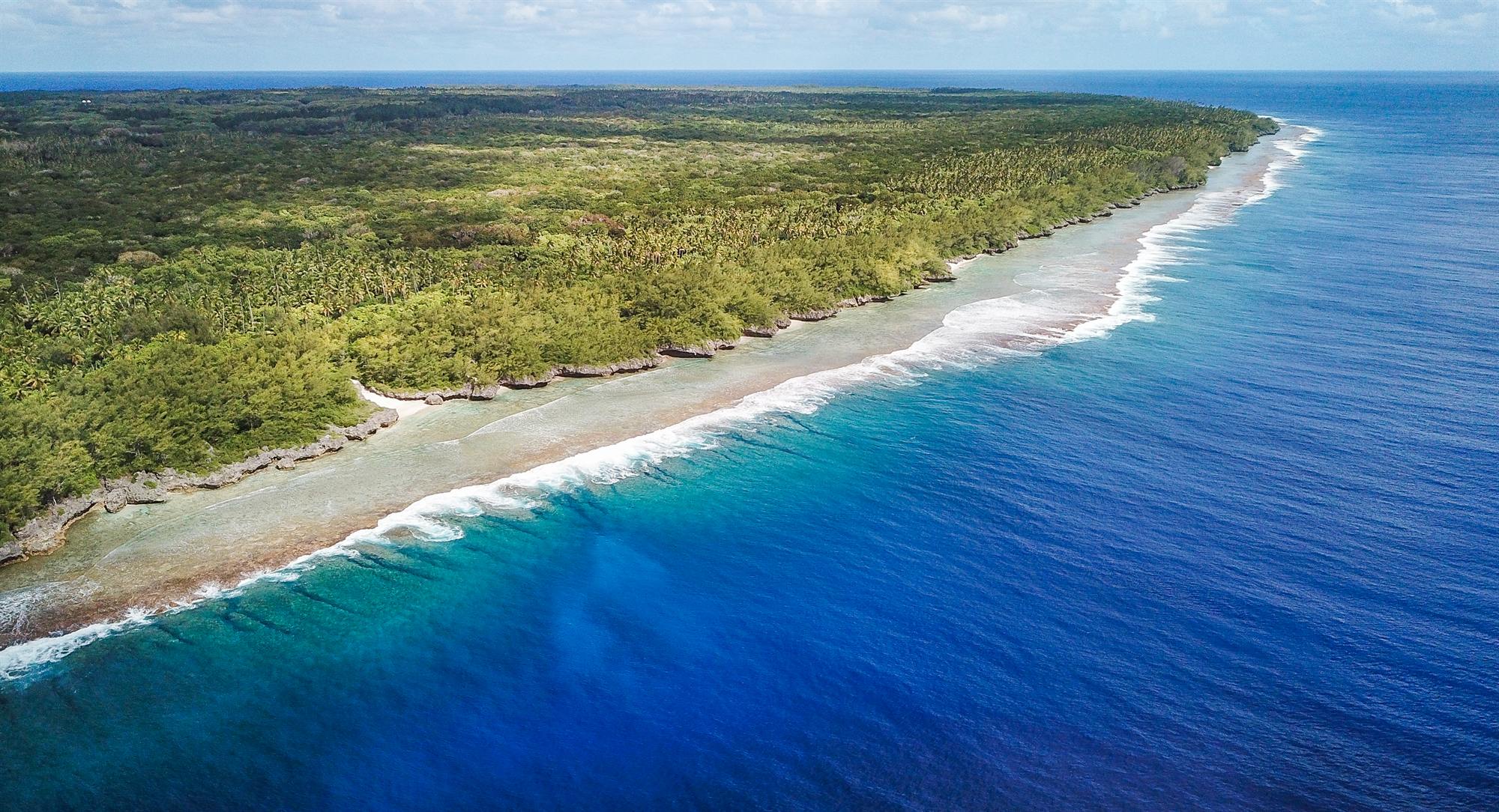 Aerial view of the coastline of Akatokamanava (Mauke), reef and ocean in the Southern Cook Islands