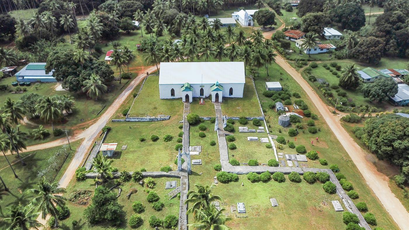 Aerial view of a church and village on Akatokamanava (Mauke)